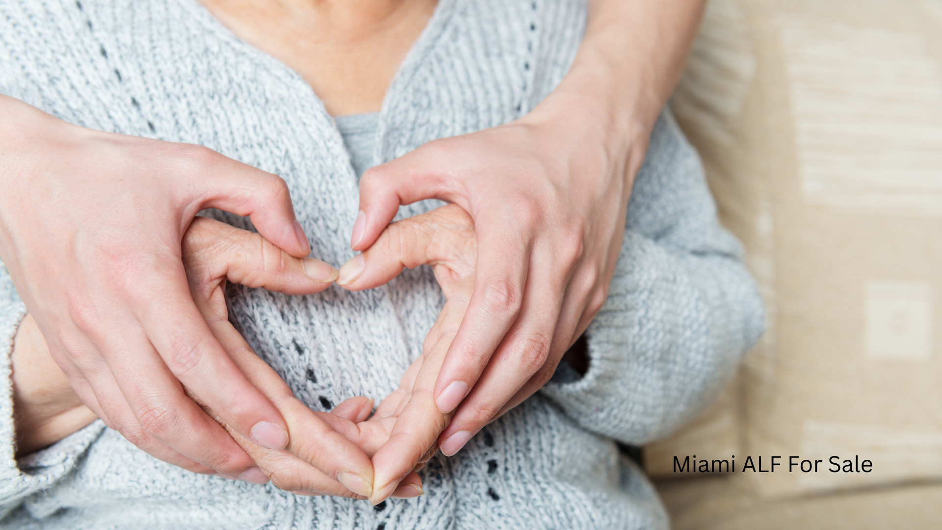 Caregiver holding hands with elderly resident, symbol of care at an ALF in Miami